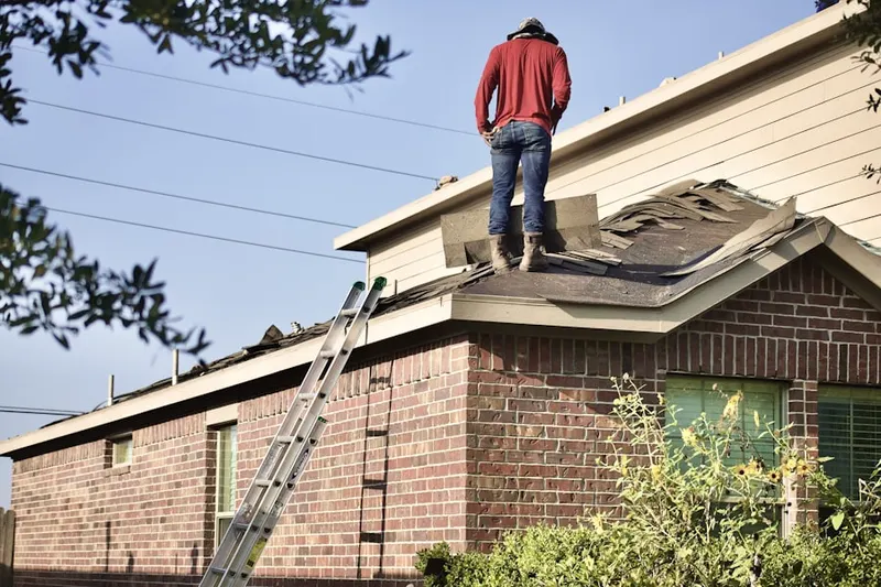 Professional roofer working on a residential roof in Manassas